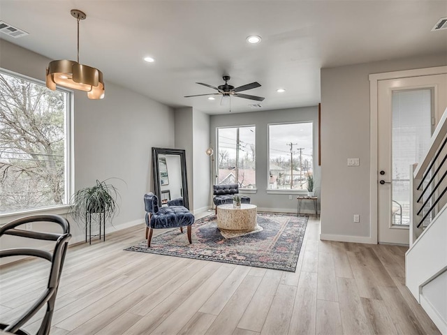 living area featuring recessed lighting, light wood-style floors, a healthy amount of sunlight, and visible vents