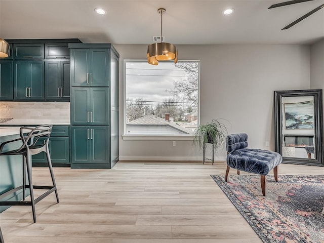 sitting room with baseboards, recessed lighting, a ceiling fan, and light wood finished floors