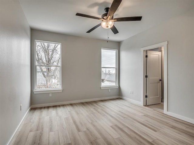 unfurnished bedroom with a ceiling fan, baseboards, and light wood finished floors