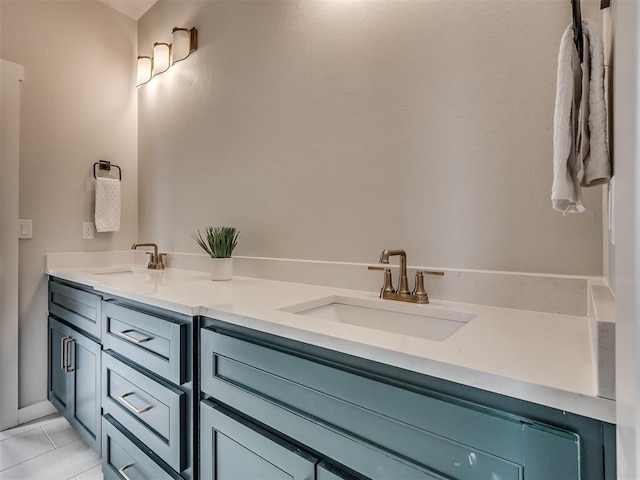 bathroom with double vanity, a sink, and tile patterned flooring