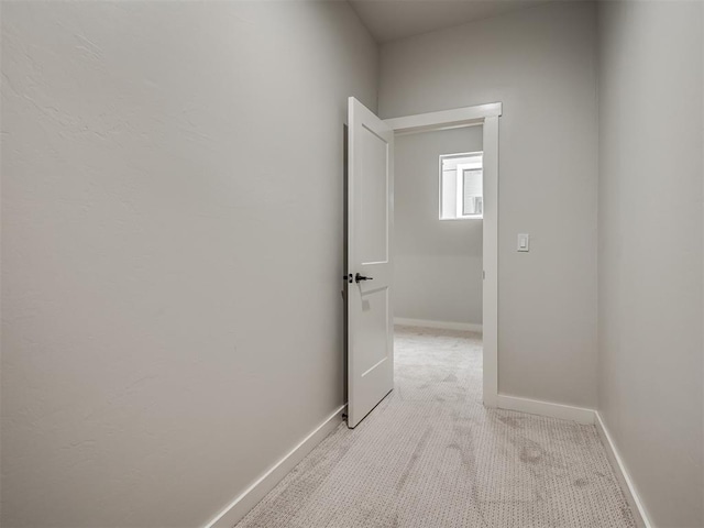 hall with light carpet and baseboards