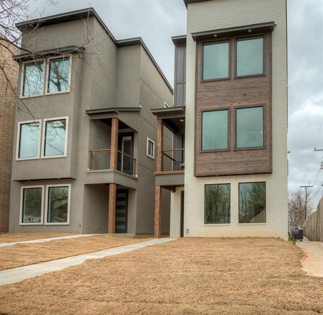 1308 NW 11th St, Oklahoma City, OK 73106 - rear view of property with brick siding, stucco siding, and a balcony