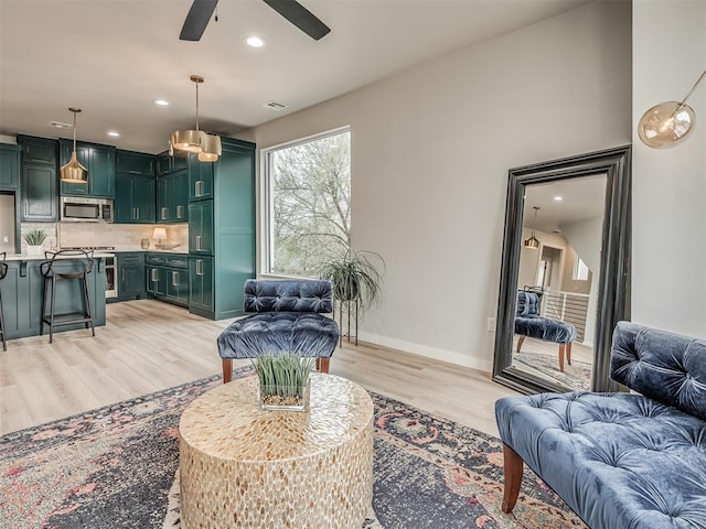1308 NW 11th St, Oklahoma City, OK 73106 - living area with light wood-type flooring, a ceiling fan, baseboards, and recessed lighting
