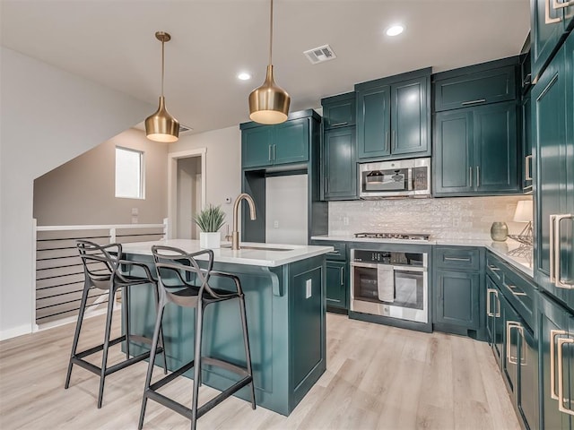 1308 NW 11th St, Oklahoma City, OK 73106 - kitchen with stainless steel appliances, a sink, light countertops, decorative backsplash, and recessed lighting