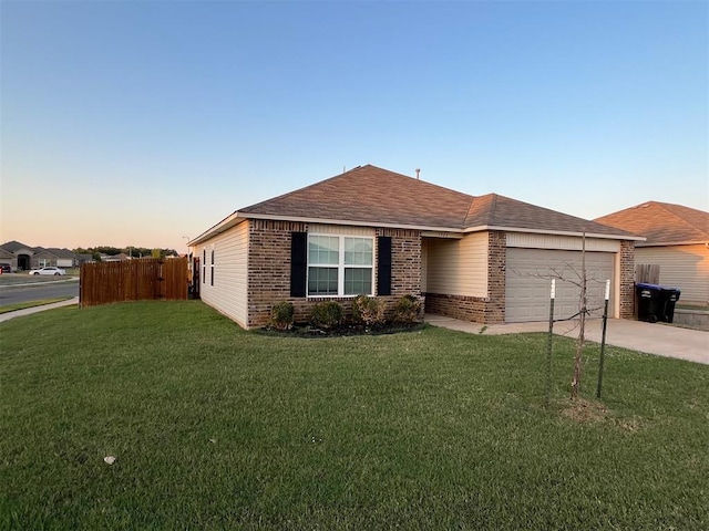 single story home featuring a yard, brick siding, concrete driveway, and a garage