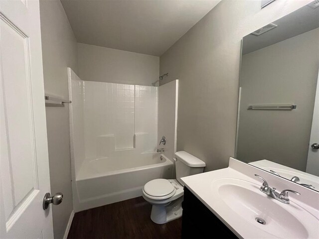 full bath featuring vanity, toilet, wood finished floors,  shower combination, and visible vents