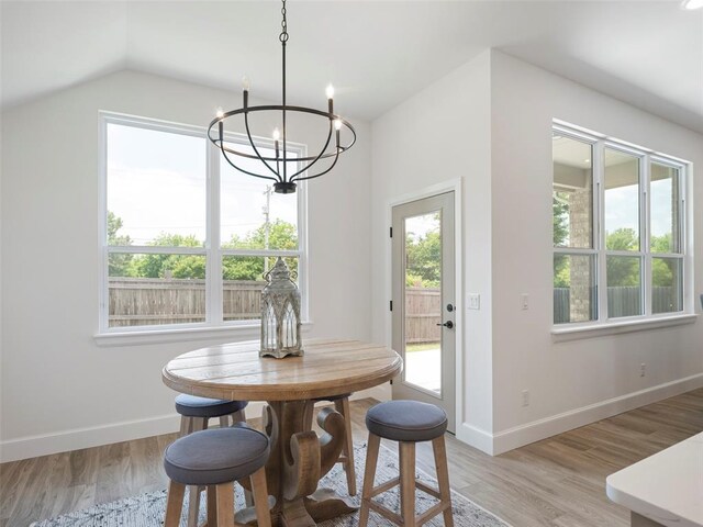 12712 NW 1st Ct, Yukon, OK 73099 - dining area featuring a chandelier, light wood-type flooring, baseboards, and lofted ceiling