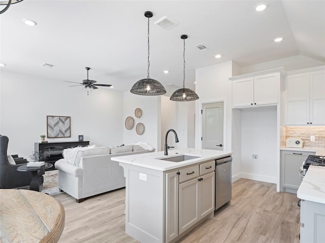12712 NW 1st Ct, Yukon, OK 73099 - kitchen featuring a sink, dishwasher, open floor plan, light wood-style floors, and recessed lighting