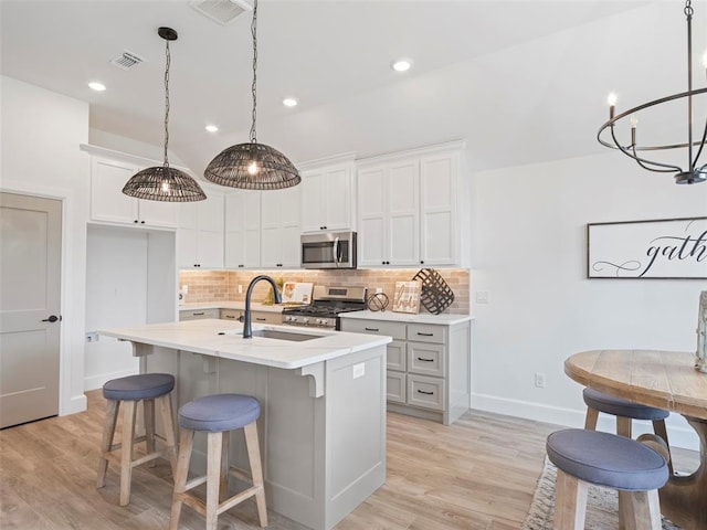 12712 NW 1st Ct, Yukon, OK 73099 - kitchen with stainless steel appliances, a sink, baseboards, tasteful backsplash, and recessed lighting