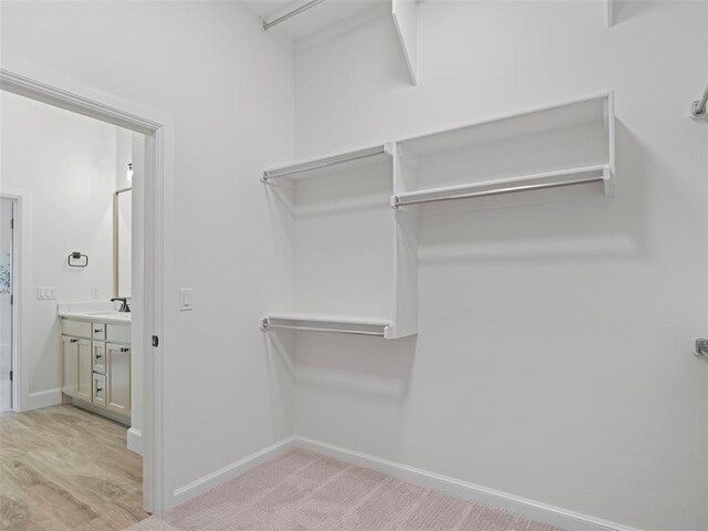 12712 NW 1st Ct, Yukon, OK 73099 - walk in closet with light wood-style flooring and a sink