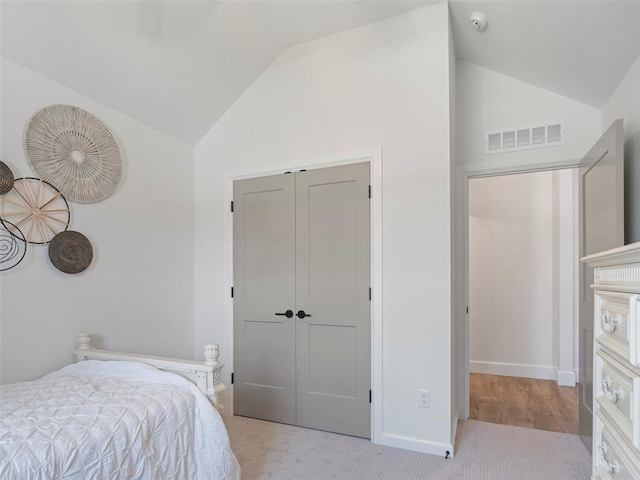 12712 NW 1st Ct, Yukon, OK 73099 - bedroom featuring carpet flooring, high vaulted ceiling, a closet, and baseboards