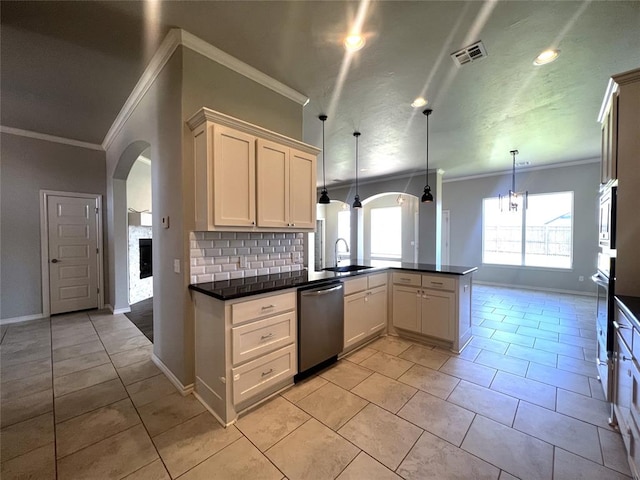 kitchen featuring dishwasher, a peninsula, crown molding, a sink, and tasteful backsplash