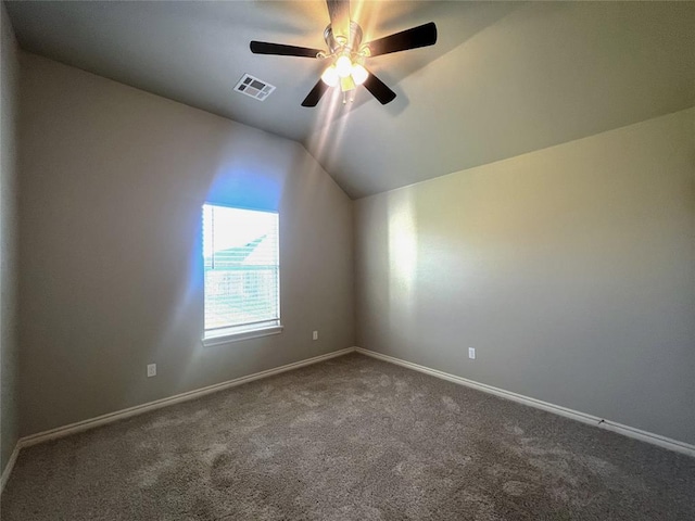 spare room with carpet flooring, lofted ceiling, ceiling fan, and baseboards