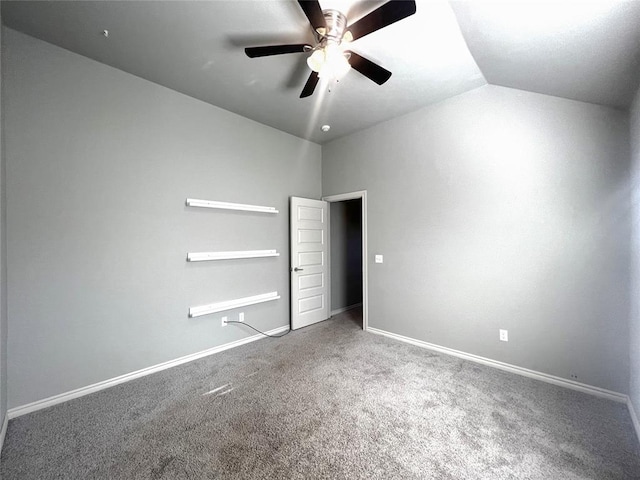 unfurnished bedroom with carpet floors, baseboards, lofted ceiling, and ceiling fan