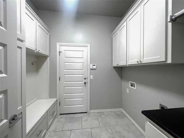 clothes washing area featuring cabinet space, hookup for a washing machine, baseboards, and light marble finish floors