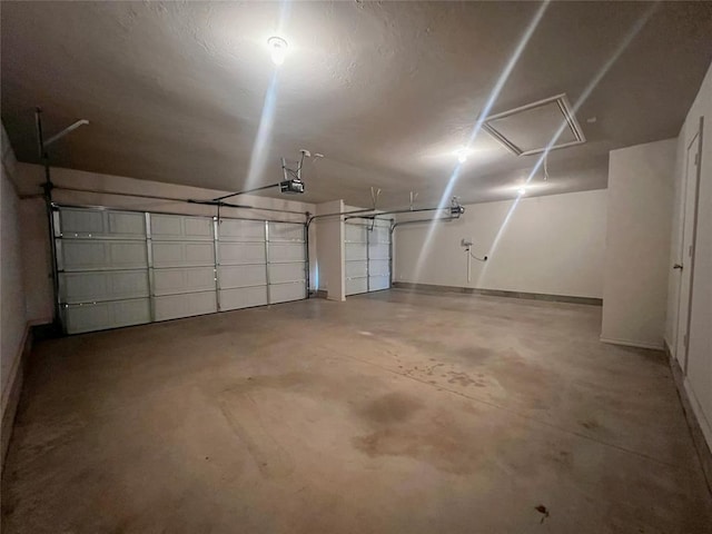 garage with baseboards and a garage door opener