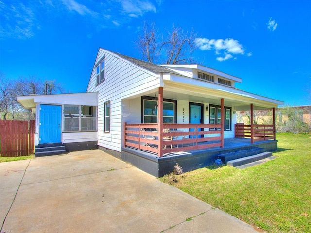 view of front of home with a porch and a front lawn