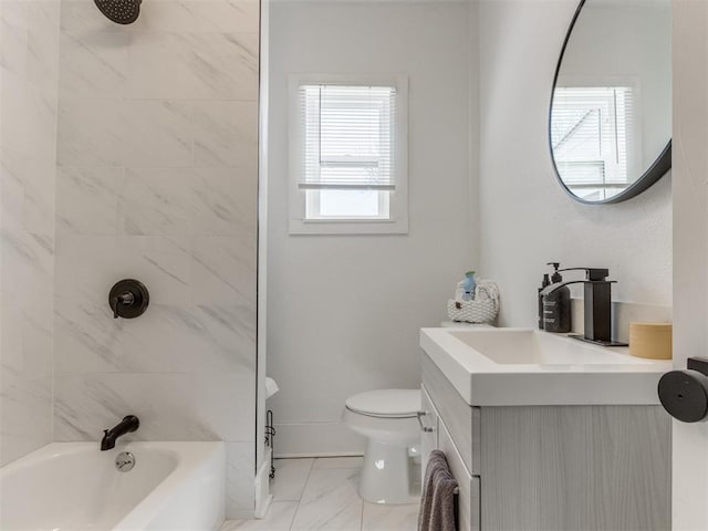 bathroom featuring vanity, toilet, baseboards, bathing tub / shower combination, and marble finish floor
