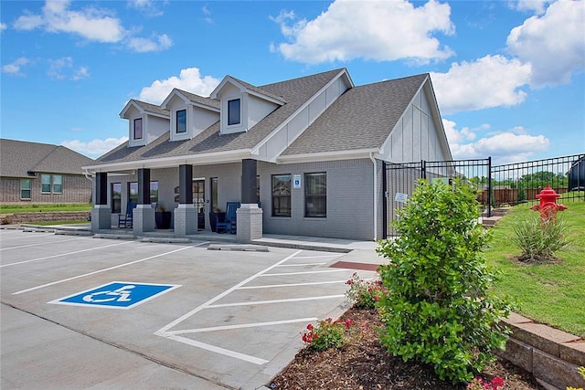 12729 NW 2nd Ter, Yukon, OK 73099 - view of front of house with fence, uncovered parking, a shingled roof, and brick siding
