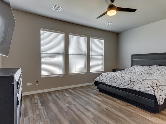 8129 NW 153rd St, Edmond, OK 73013 - bedroom with light wood-style floors, multiple windows, and baseboards