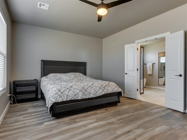 8129 NW 153rd St, Edmond, OK 73013 - bedroom featuring wood finished floors, multiple windows, and baseboards