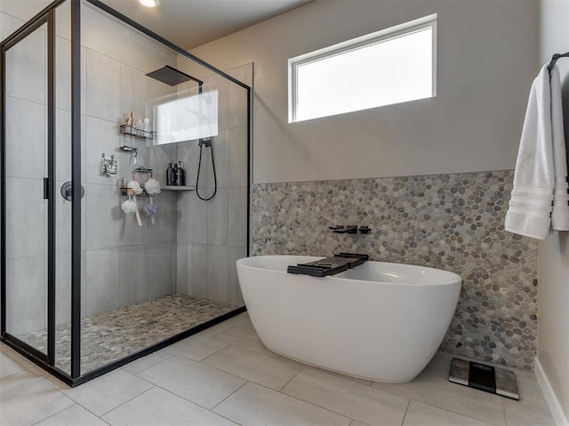8129 NW 153rd St, Edmond, OK 73013 - bathroom with a soaking tub, a stall shower, tile walls, and wainscoting