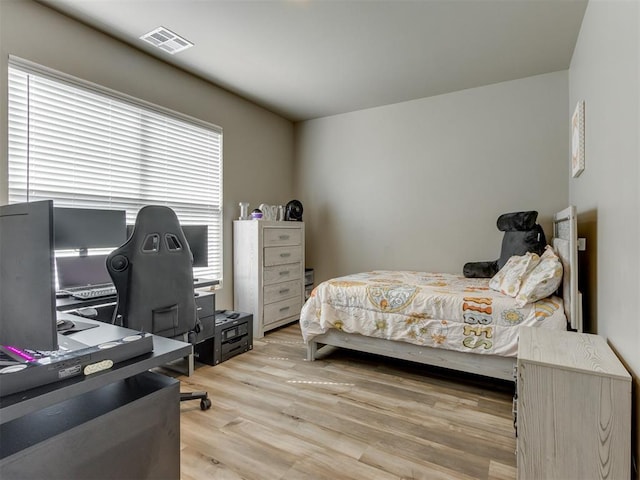 8129 NW 153rd St, Edmond, OK 73013 - bedroom with light wood-style floors and a desk