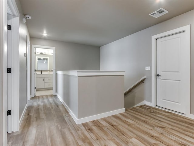 8129 NW 153rd St, Edmond, OK 73013 - hall featuring an upstairs landing, light wood-style flooring, and baseboards