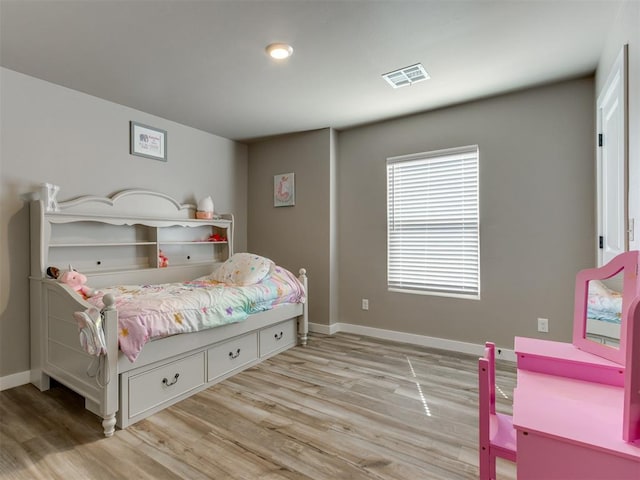 8129 NW 153rd St, Edmond, OK 73013 - bedroom with light wood-style floors and baseboards