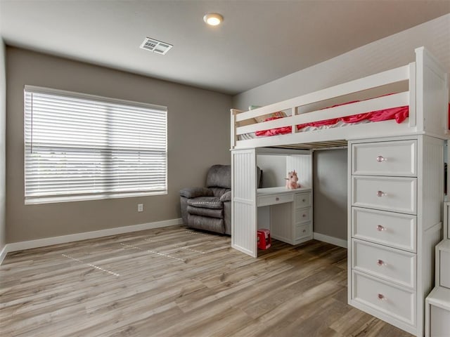 8129 NW 153rd St, Edmond, OK 73013 - bedroom with light wood finished floors and baseboards