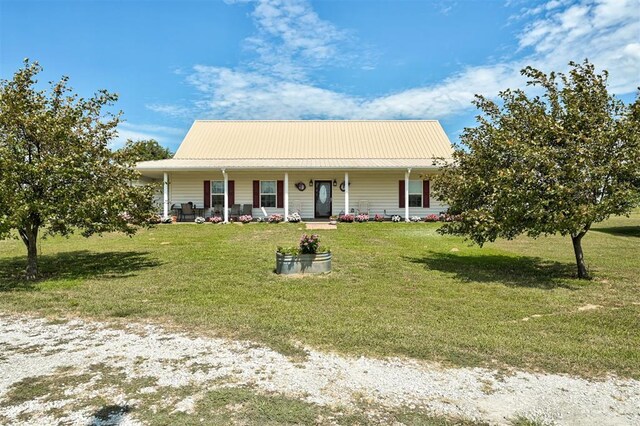 9122 Ns 3540th Rd, Prague, OK 74864 - view of front of property with a porch, a front yard, and metal roof