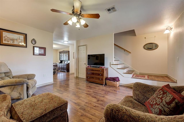 9122 Ns 3540th Rd, Prague, OK 74864 - living room with visible vents, baseboards, ceiling fan, wood finished floors, and stairway