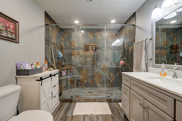 9122 Ns 3540th Rd, Prague, OK 74864 - bathroom featuring vanity, wood tiled floor, toilet, and a shower stall