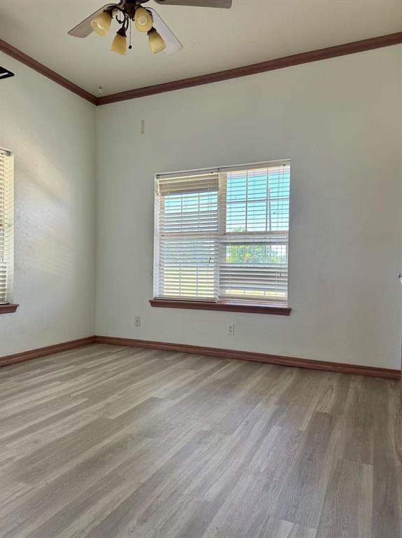 817 SW 16th St, Newcastle, OK 73065 - empty room with wood finished floors, ceiling fan, baseboards, and ornamental molding