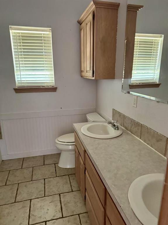 817 SW 16th St, Newcastle, OK 73065 - bathroom with double vanity, toilet, healthy amount of natural light, and wainscoting
