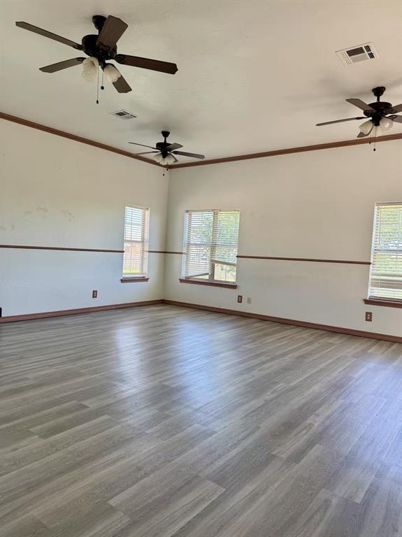 817 SW 16th St, Newcastle, OK 73065 - unfurnished room with wood finished floors, baseboards, crown molding, and ceiling fan