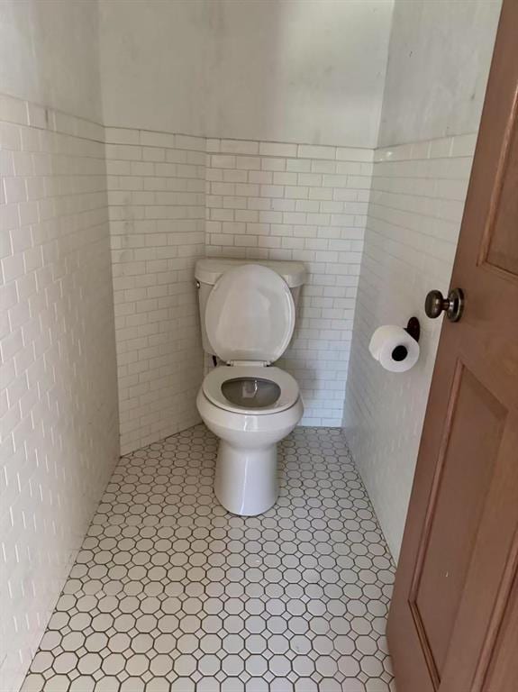 817 SW 16th St, Newcastle, OK 73065 - bathroom featuring toilet, tile walls, and tile patterned floors