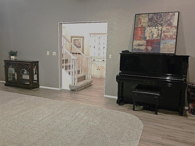 1402 Broad Acres Dr, Norman, OK 73072 - living area with wood finished floors, stairway, and a textured wall