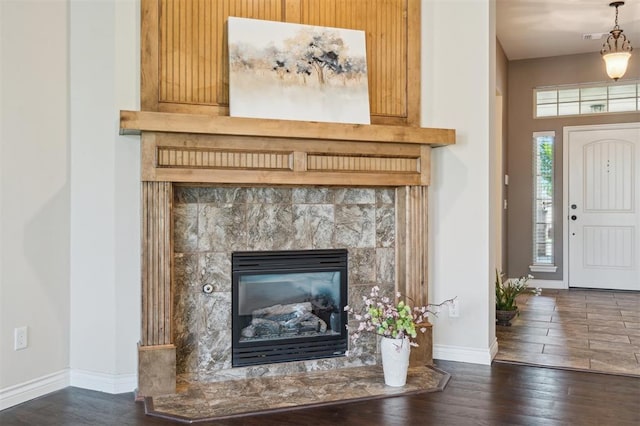 708 Havasu Dr, Norman, OK 73071 - detailed view of wood finished floors, baseboards, and a tile fireplace