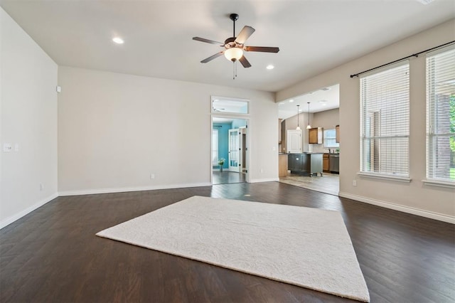 708 Havasu Dr, Norman, OK 73071 - unfurnished living room with dark wood-style flooring, ceiling fan, recessed lighting, and baseboards