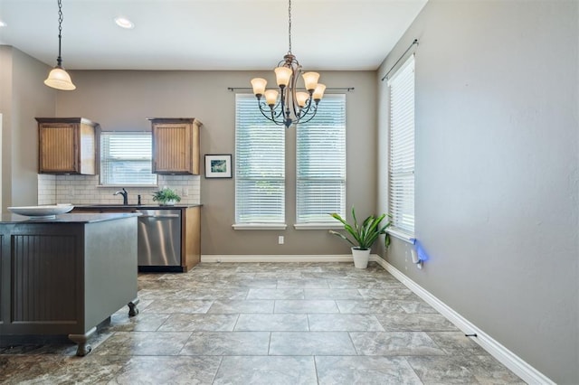 708 Havasu Dr, Norman, OK 73071 - kitchen with stainless steel dishwasher, dark countertops, and healthy amount of natural light