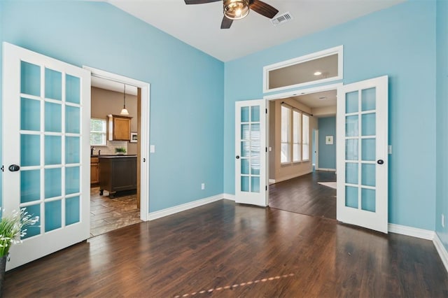 708 Havasu Dr, Norman, OK 73071 - spare room featuring french doors, dark wood-type flooring, ceiling fan, and baseboards