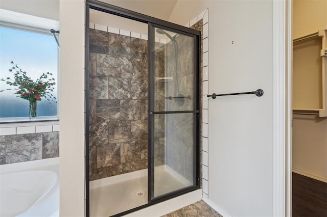 708 Havasu Dr, Norman, OK 73071 - bathroom with a stall shower, a bath, a spacious closet, baseboards, and healthy amount of natural light