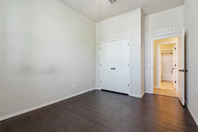 708 Havasu Dr, Norman, OK 73071 - unfurnished bedroom featuring dark wood-type flooring, baseboards, and a closet