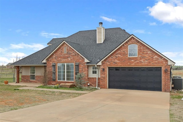 3311 Terrace Hills Rd, Piedmont, OK 73078 - traditional-style home with driveway, brick siding, a shingled roof, and central air condition unit
