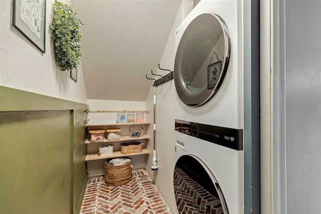 3311 Terrace Hills Rd, Piedmont, OK 73078 - clothes washing area featuring stacked washer and dryer, brick floor, and laundry area