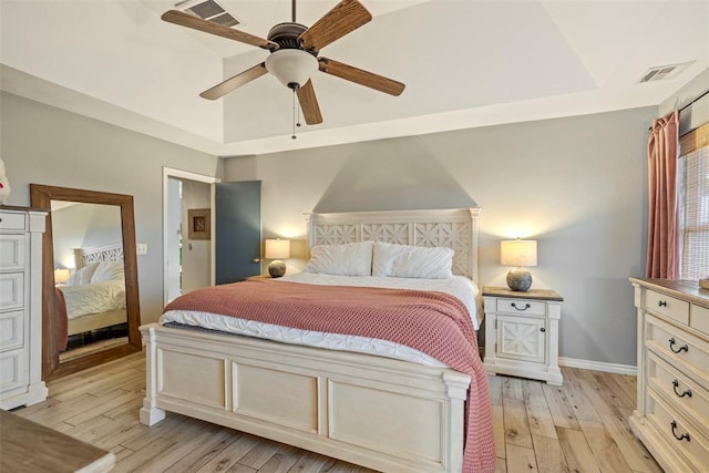 3311 Terrace Hills Rd, Piedmont, OK 73078 - bedroom featuring a tray ceiling, visible vents, ceiling fan, and light wood-type flooring