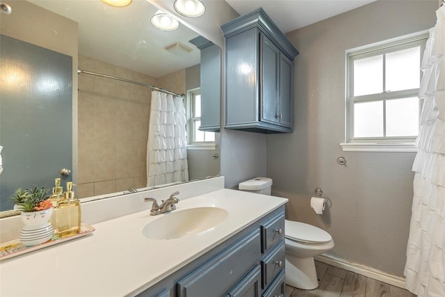 3311 Terrace Hills Rd, Piedmont, OK 73078 - bathroom with visible vents, baseboards, toilet, wood finished floors, and vanity