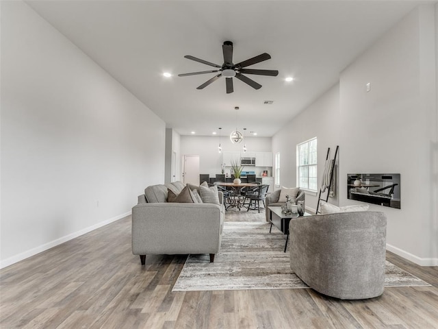 3100 NE 17th St, Oklahoma City, OK 73121 - living area featuring ceiling fan, light wood-style floors, baseboards, and recessed lighting