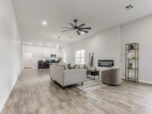 3100 NE 17th St, Oklahoma City, OK 73121 - living area with light wood-style flooring, a ceiling fan, baseboards, and recessed lighting